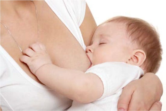 Woman breast feeding a baby